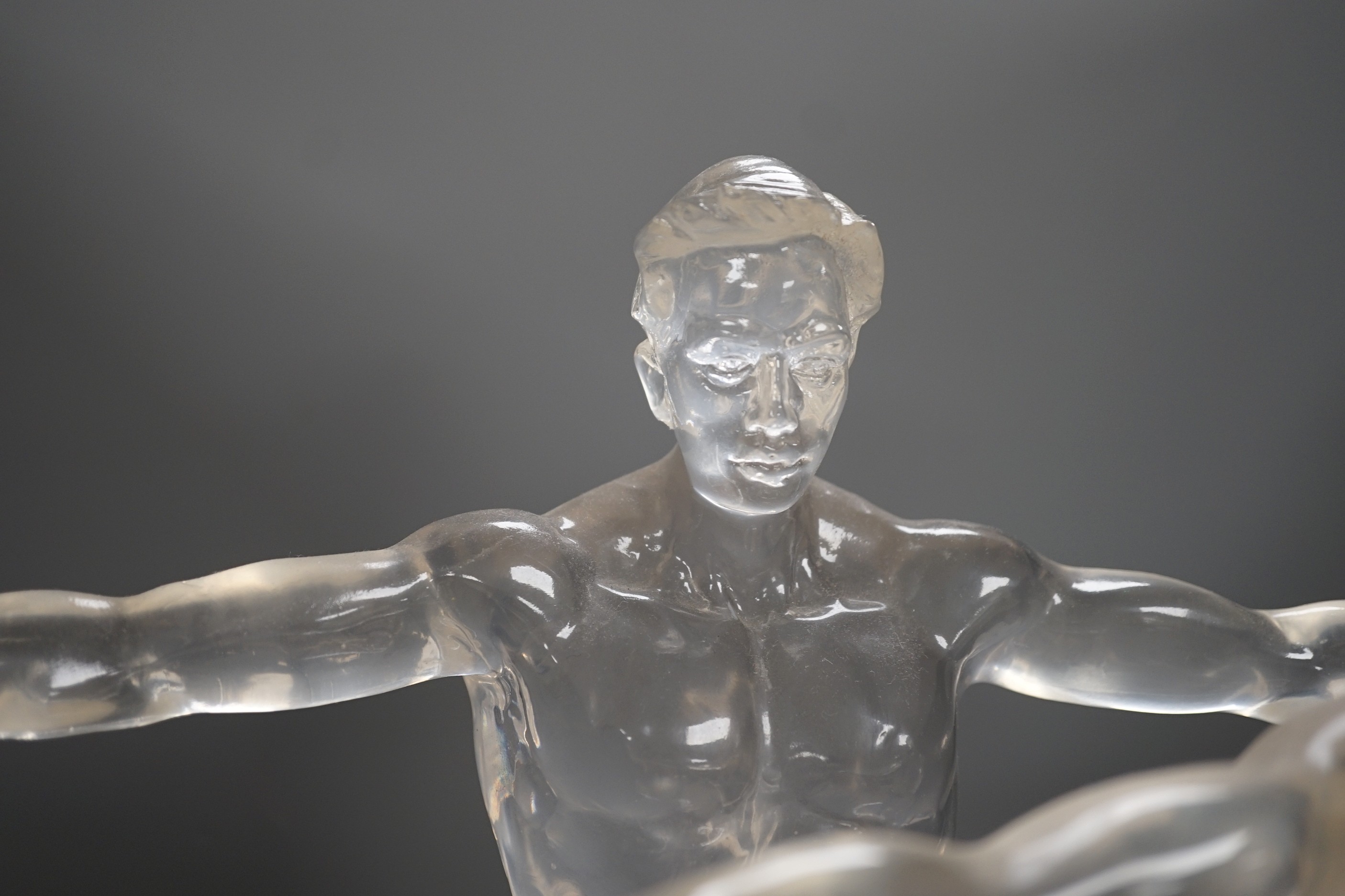 A pair of clear perspex models of male swimmers, 57cms high